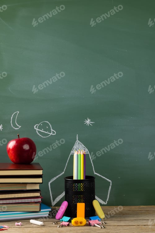 Preview: Image of school supplies, apple and notebook over drawings on black board