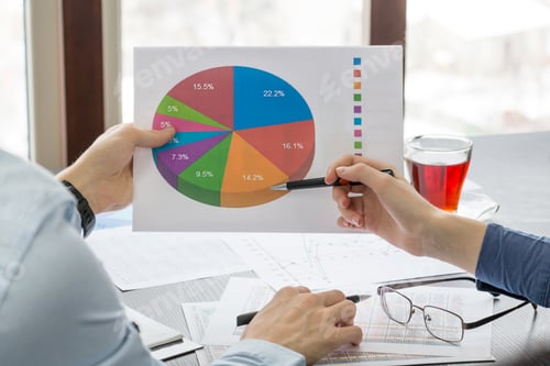 Preview: pie chart in the hands of young people closeup