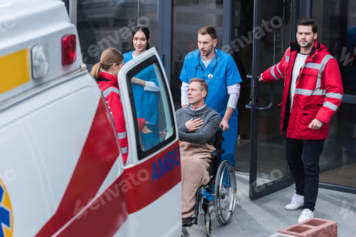 Preview: doctors helping man on wheelchair get to ambulance