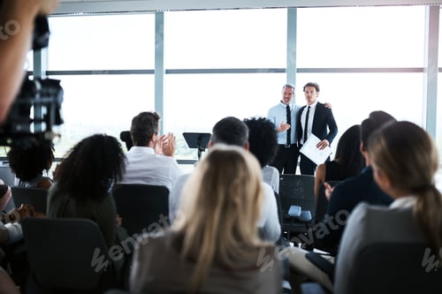 Preview: Shot of businesspeople applauding a colleague during a conference in an office