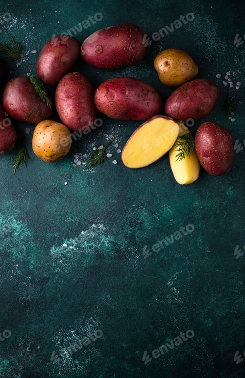 Preview: Raw uncooked potato on green table