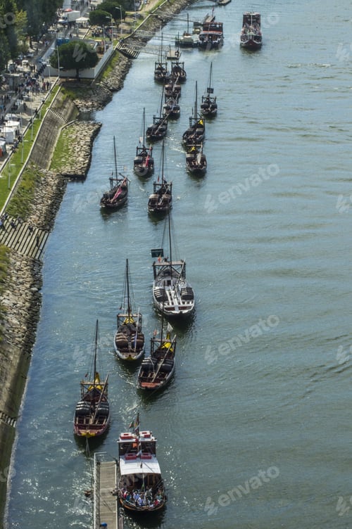 Preview: Vertical shot of boats floating through a river in the daylight