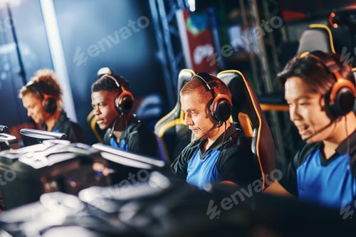 Preview: Team of four professional cybersport gamers wearing headphones