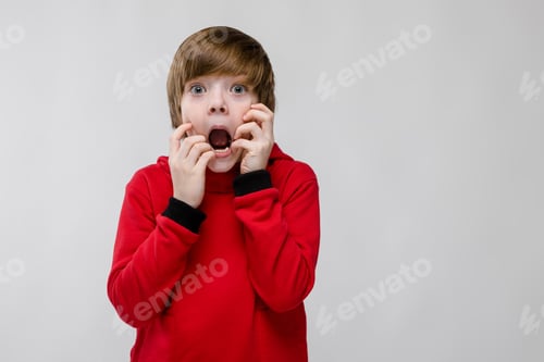 Preview: Scared teenage boy in fashionable clothes