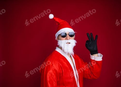 Preview: Playful cool funny naughty tourist grandfather Santa shows to accept the signs