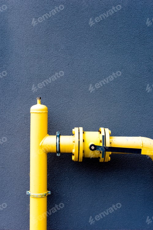 Preview: Yellow gas pipe in front of a blue wall