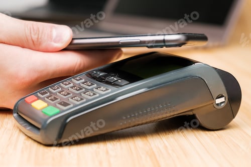 Preview: Man uses wireless terminal contactless payment with smartphone