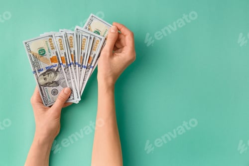 Preview: Dollars in hands on green background top view copy space