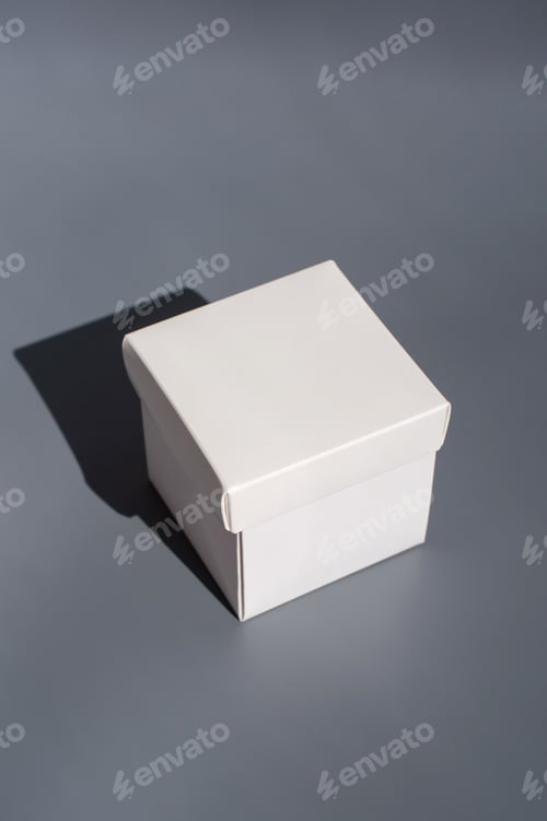 Preview: Minimalist white gift box with shadow on gray background