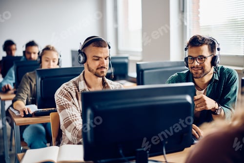 Preview: College students cooperating while e-learning on computer class in the classroom.