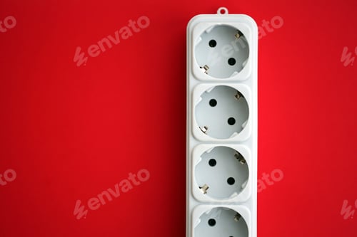 Preview: White electrical multi plug extender with european socket on bright red background