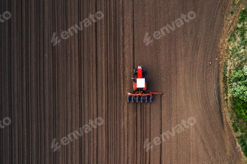 Preview: Top view of tractor planting corn seed in field