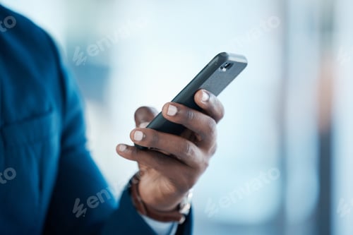 Preview: Shot of an unrecognisable businessman using a smartphone in a modern office
