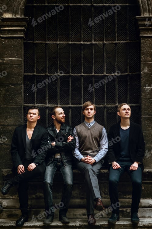 Preview: stylish handsome group of confident and successful men standing on the background of city street