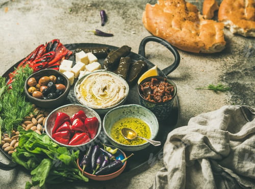 Preview: Mediterranean meze starter fingerfood platter in tray, selective focus