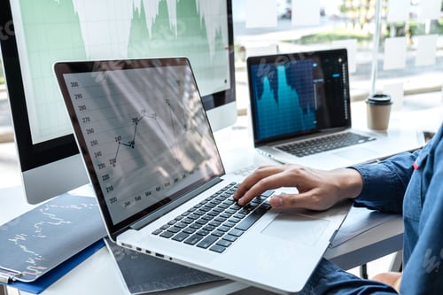 Preview: Businessman investor working in traders marketing and planning and analyzing pointing on the stock