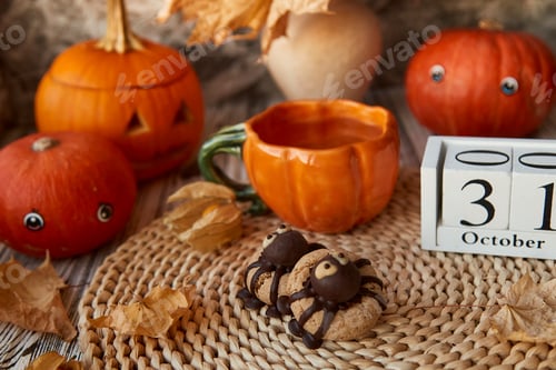 Preview: Funny Halloween cookies in shape of spider and cup of tea in shape of pumpkin