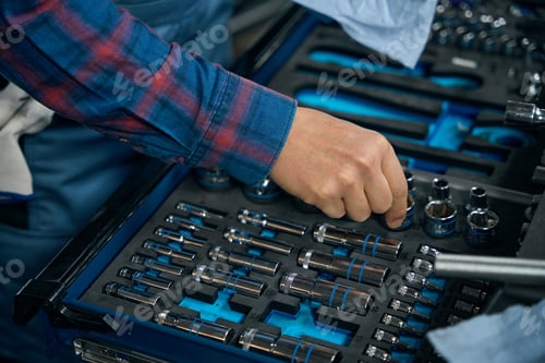 Preview: Professional worker choose instruments for repair in tire fitting