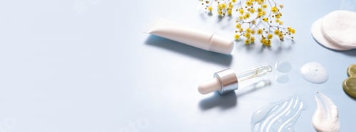 Preview: Serum in dropper and smears cosmetic cream with facial massager