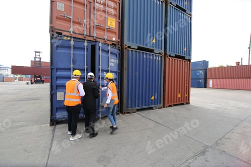Preview: Foreman control loading Containers box from Cargo freight ship for import export.