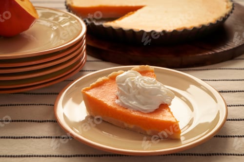 Preview: Piece of fresh homemade pumpkin pie with whipped cream on table
