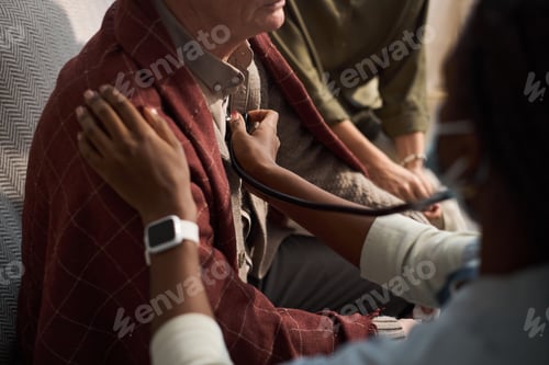 Preview: Middle Aged Man Receiving Medical Examination from Black Woman Doctor