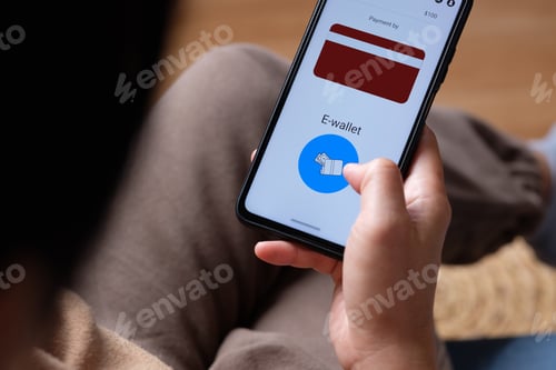 Preview: close up woman choose payment online on shopping mobile app on sofa at home