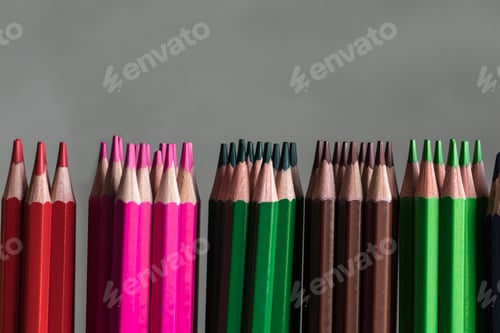 Preview: drawing colorful wooden pencils in a row rainbow on the grey background. Drawing, hobby, occupation