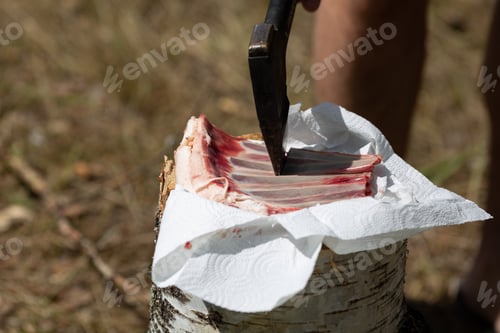 Preview: A man is chopping lamb ribs