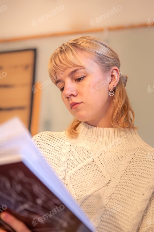 Preview: Young attractive woman reading a book. Concept of learning and self-development.