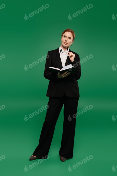 Preview: A poised TV presenter in elegant black formal attire pondering on a green chroma key backdrop