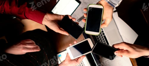 Preview: top view of peoples hands holding mobile phones