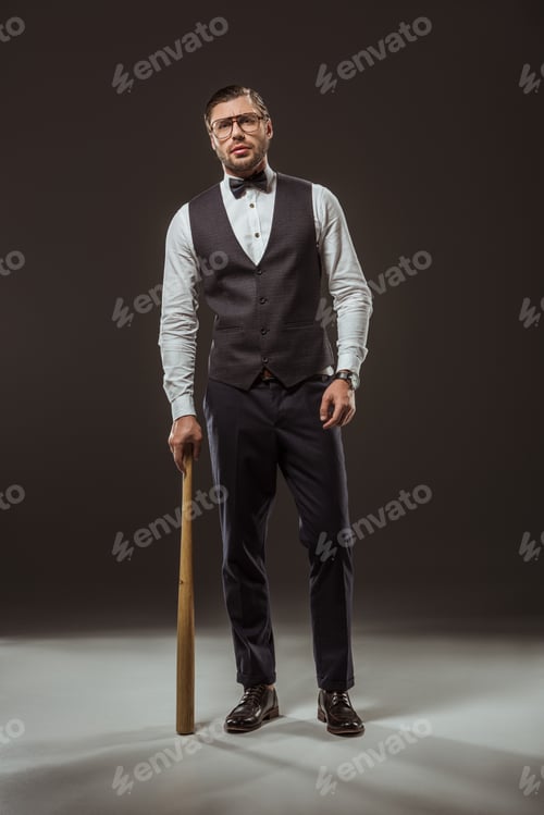 Preview: handsome stylish man standing with baseball bat on black