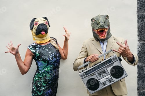 Preview: Happy senior couple having fun wearing dog and t-rex mask