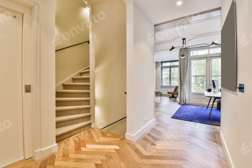 Preview: a living room with a staircase and a blue rug