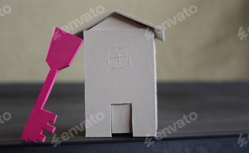 Preview: Toy house and a key representing mortgage