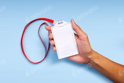 Preview: Hand Holding A Blank ID Card With A Red Lanyard Against A Light Blue Background