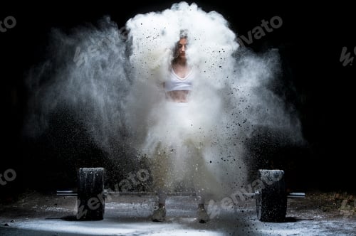 Preview: Woman working out with weights in the gym