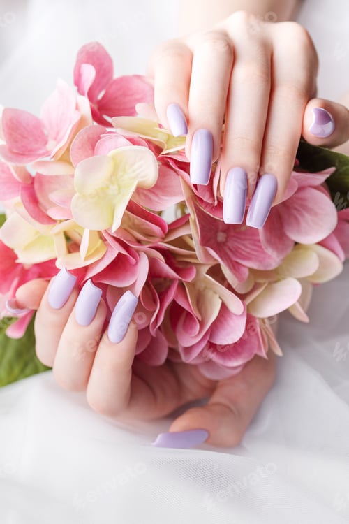 Preview: Girl's hands with a soft purple manicure.