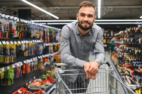 Preview: Portrait of happy mature man standing in hardware store