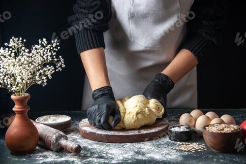 Preview: front view female cook rolling out dough on dark background pastry job raw dough hotcake bakery pies