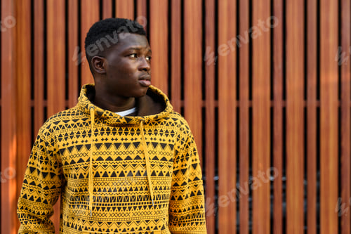 Preview: Close up of young black African man thinking while looking at di