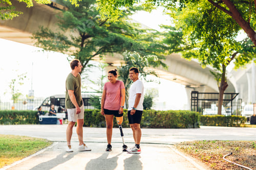 Preview: Friend support Friend with a prosthetic leg while exercising outdoor.