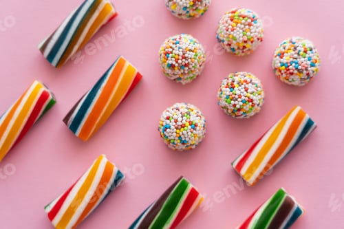 Preview: Flat lay with colorful blurred sweets on pink background