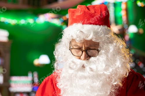 Preview: Father Christmas reading a wish list from children in his North Pole log cabin