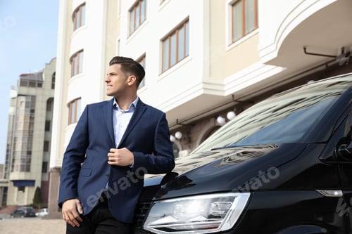 Preview: Handsome man near modern car on city street