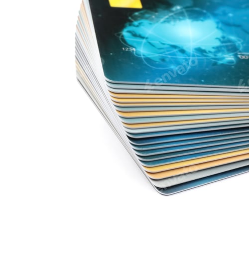 Preview: Stack of plastic credit cards on white background, closeup