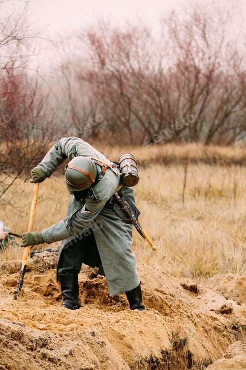 Preview: Re-enactor Dressed As German Wehrmacht Infantry Soldier In World War Ii With Shovel Digs Trench