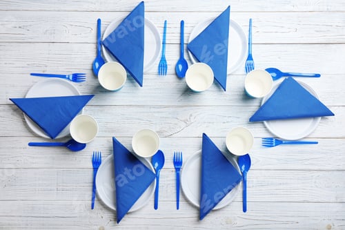 Preview: Table setting with plastic dishware on wooden background, flat lay