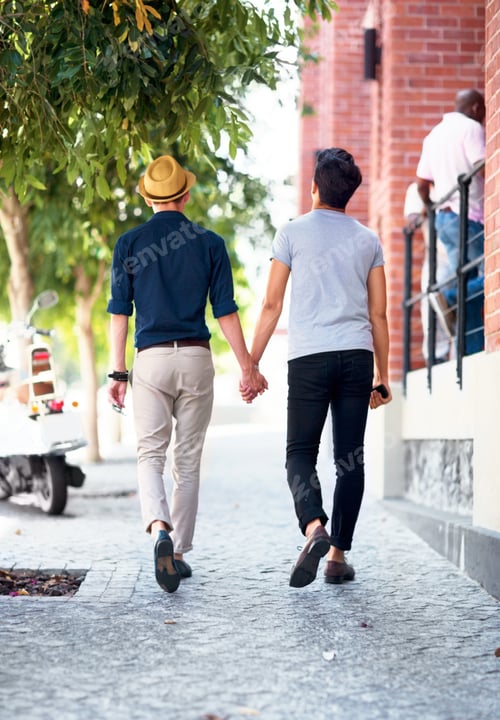 Preview: Love has no restrictions. Shot of a young gay couple waling outdoors while holding hands.